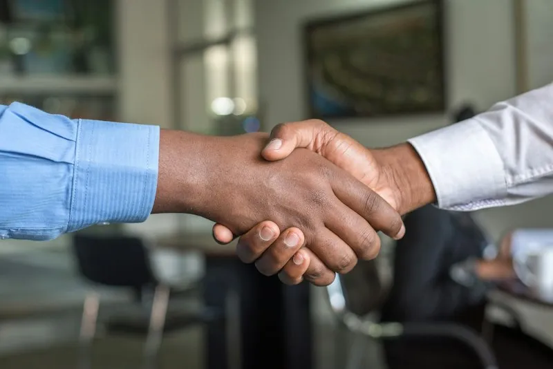 Signing a job offer contract at an office desk
