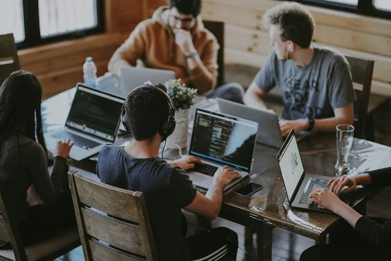 Small team of researchers reviewing documents at a bright workspace